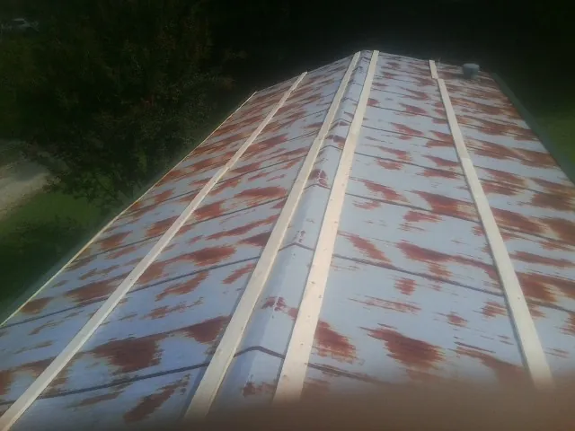 Rusted metal roof panels with new wood purlins before replacement — Storm Damage Roof Repair in Mendham by Roofing Brothers
